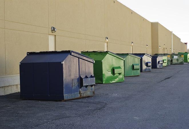 an empty dumpster ready for use at a construction site in Allston, MA